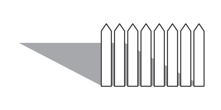 A vertical row of eight picket fence posts with pointed tops casts a solid, triangular shadow to the left on a white background, evoking concepts of defensible space in areas of high population density.