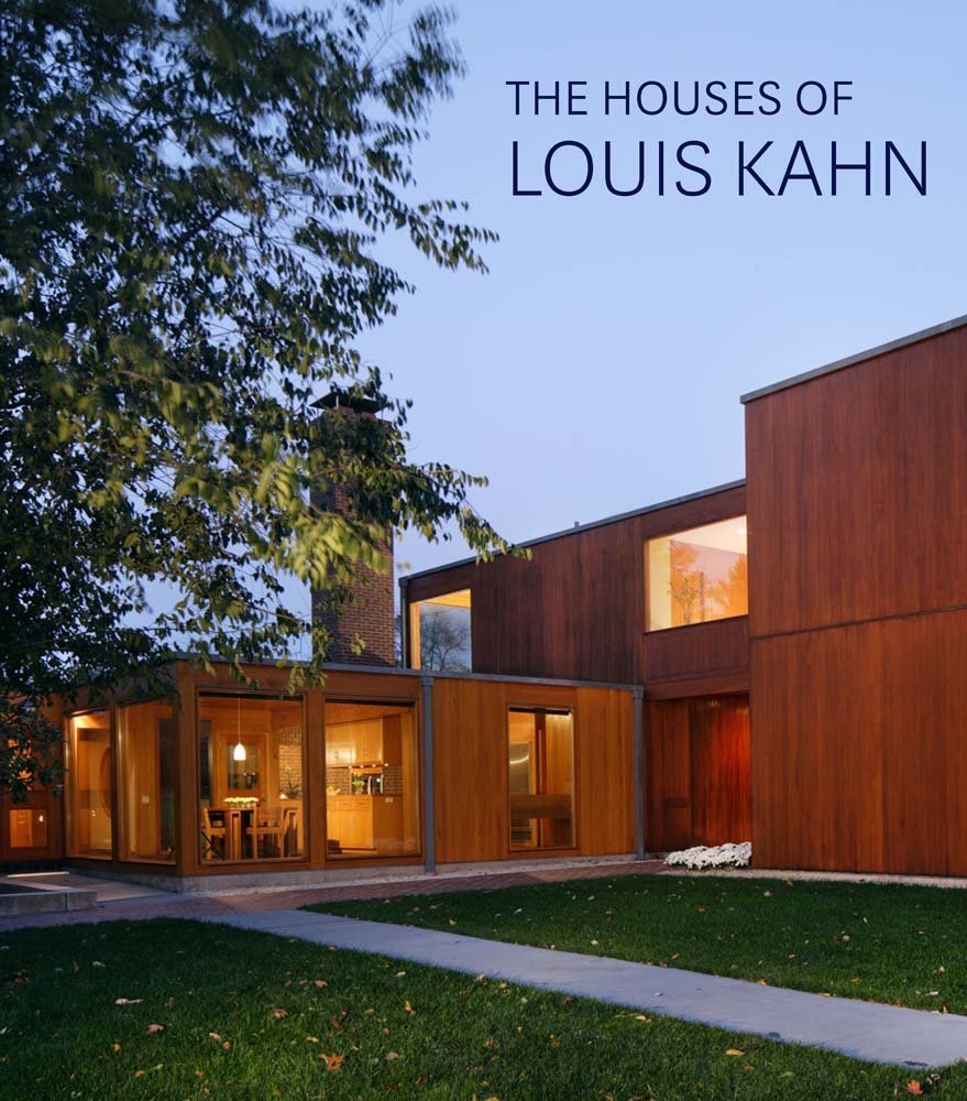 A modern house with large wooden exterior panels and expansive windows sits behind a green lawn with a concrete path. The text The Houses of Louis Kahn appears in the upper right corner, perfect for any architect or student.