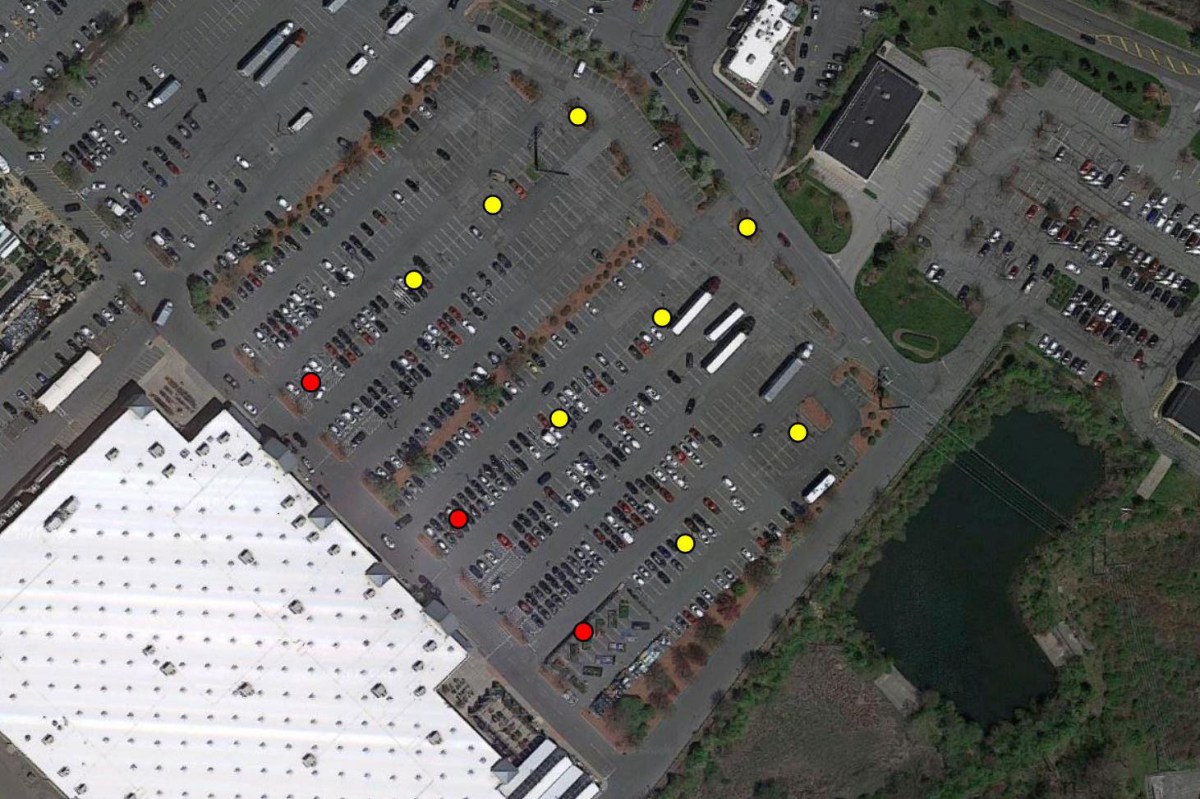 Aerial view of a large Walmart parking lot with several cars and trucks. Colored dots (yellow and red) mark various spots throughout the lot. Surrounding buildings, roads, and a pond highlight this case study scene.